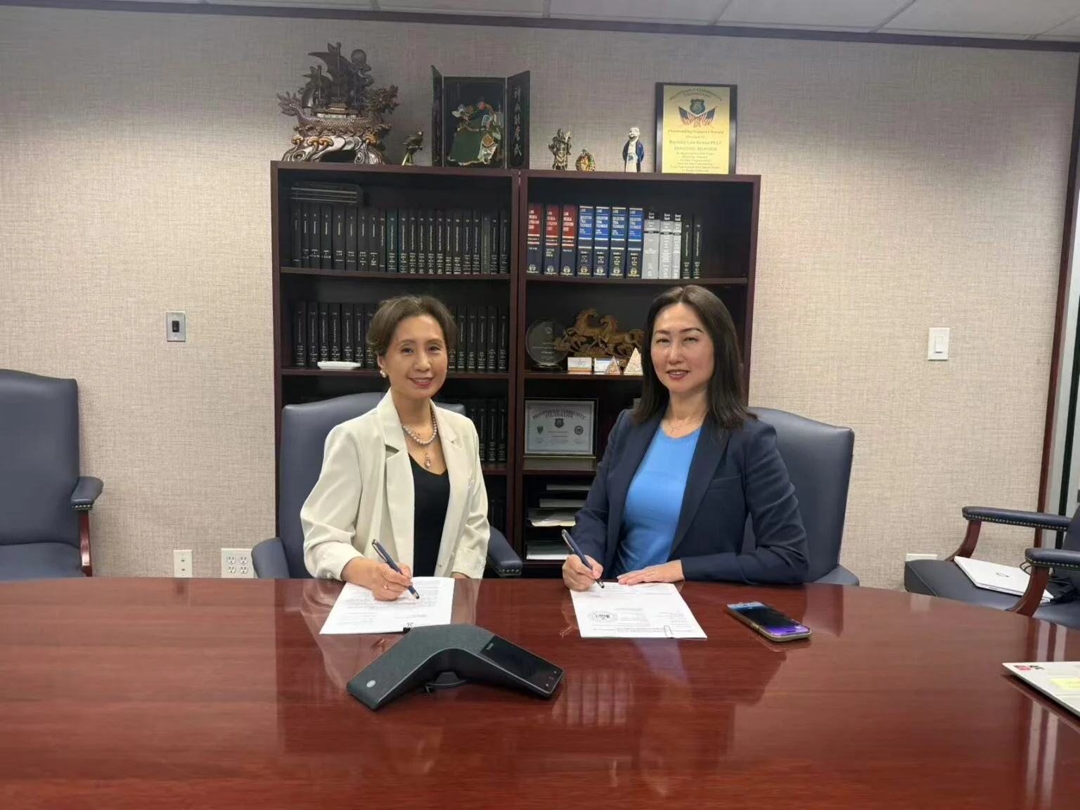 AAWCC NY founders Helen Fu and Anna Zhu signing partnership agreement, Flushing New York